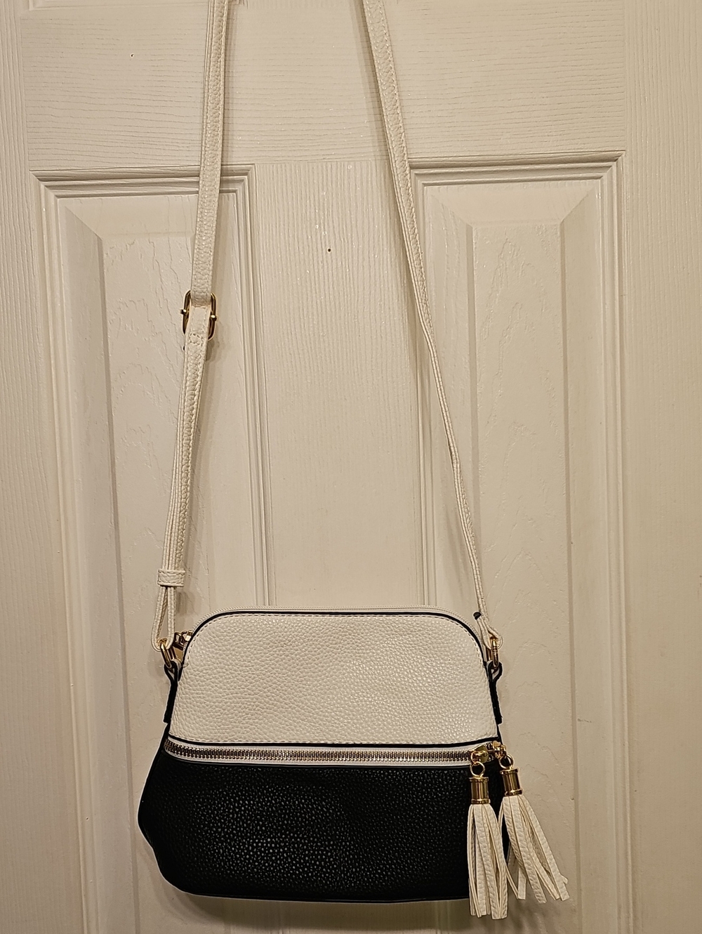 Two-Tone White and Black Crossbody Bag with Tassel Accent